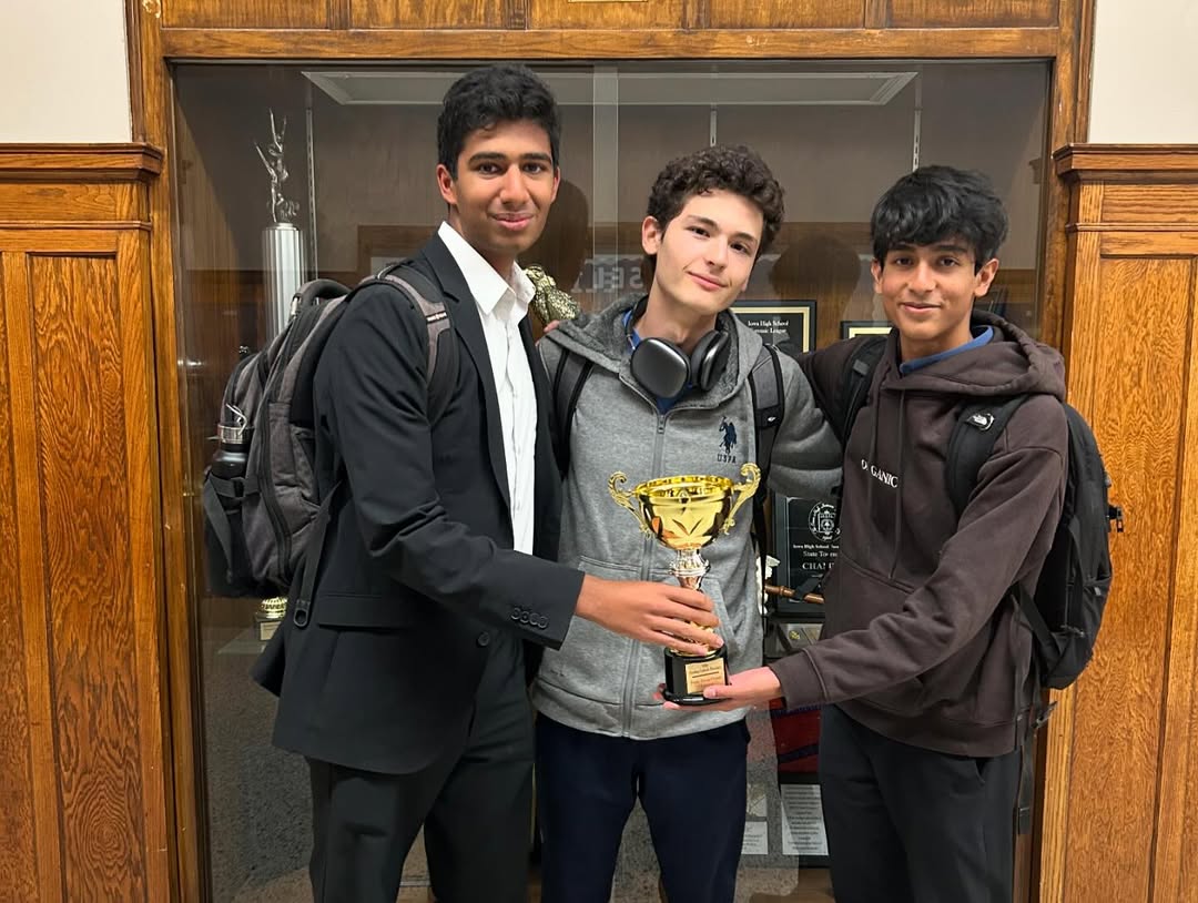 Debate champions with trophy